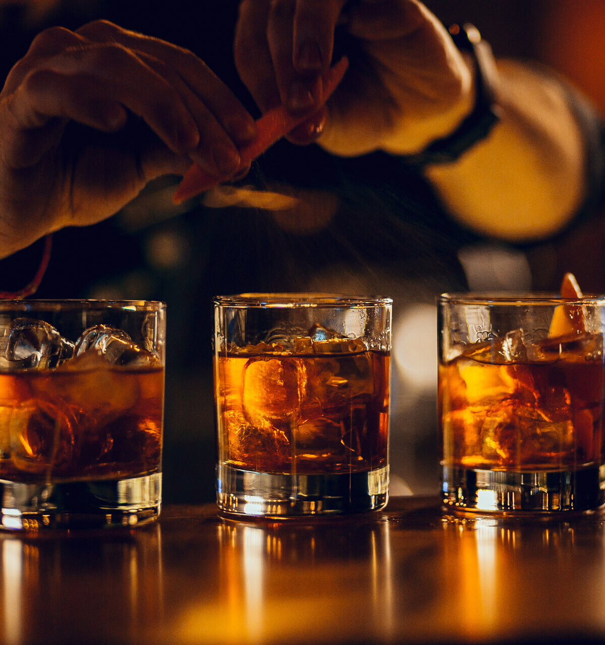drei Cocktails an der Bar von Hand zubereiten